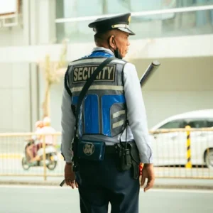 Security guard in uniform standing on city street maintaining public safety